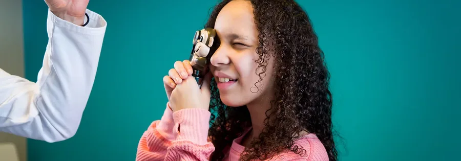 Dr Uma showing a young friend how the otoscope works