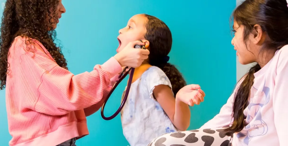 Dr Uma's pediatric patients playing with a stethoscope at the Huntersville, NC office